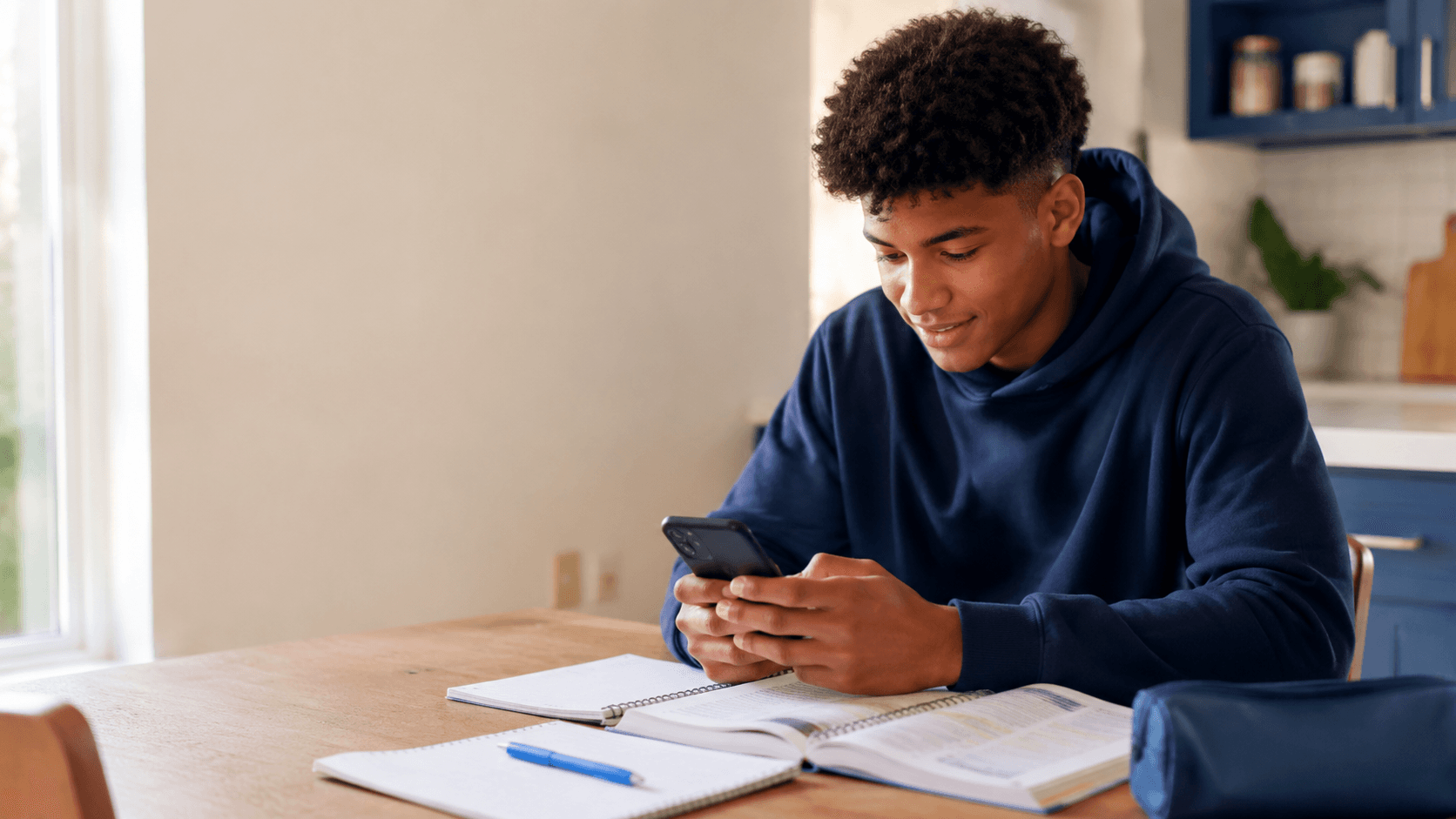 Student revising at home on their phone